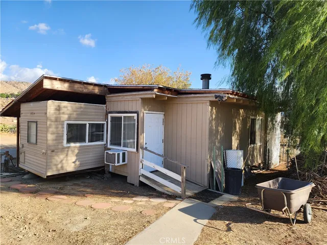 a view of house with a yard