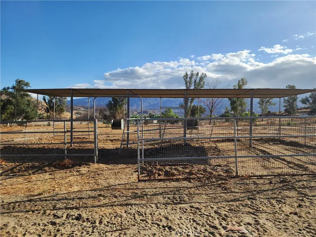 a view of a house with wooden fence