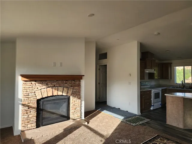 a kitchen with granite countertop a stove top oven and cabinets