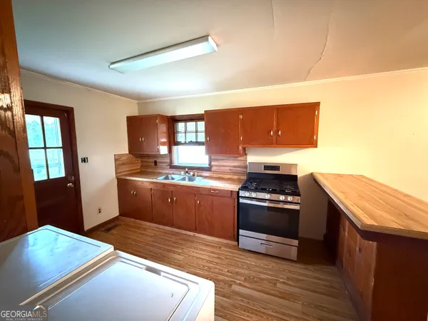 a kitchen with stainless steel appliances granite countertop a stove a sink and a refrigerator