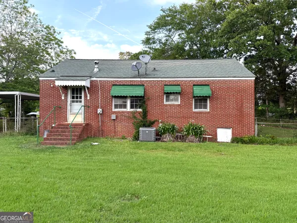 a front view of house with yard and trees