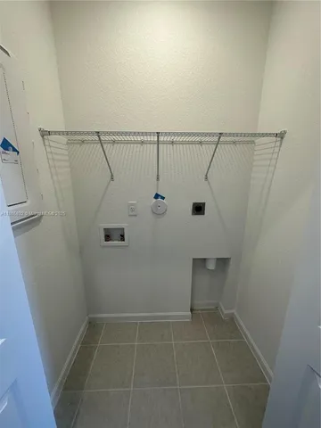 a room with a furniture and a refrigerator