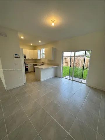 a view of a kitchen with a sink and a stove top oven