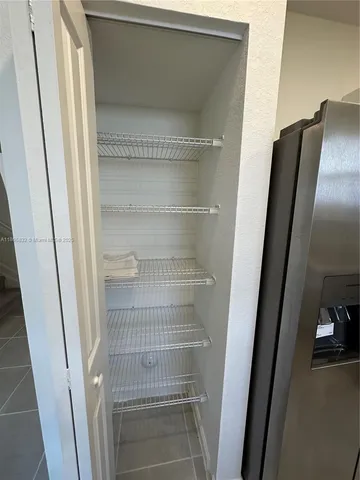 a kitchen with stainless steel appliances a refrigerator sink and microwave