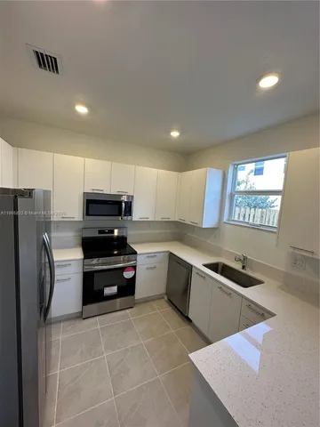 a kitchen with stainless steel appliances a refrigerator and a stove