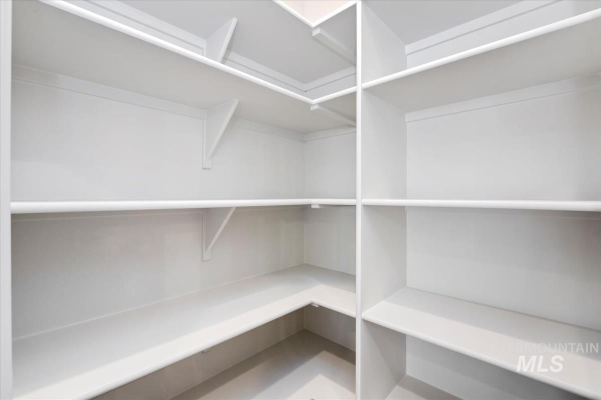 752 South Calhoun Lane Star, ID 83669 - Photo 14 of 45 Spacious walk-in pantry featuring multiple levels of built-in shelving, white finish throughout, and durable construction