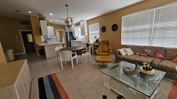 a living room with furniture and a chandelier