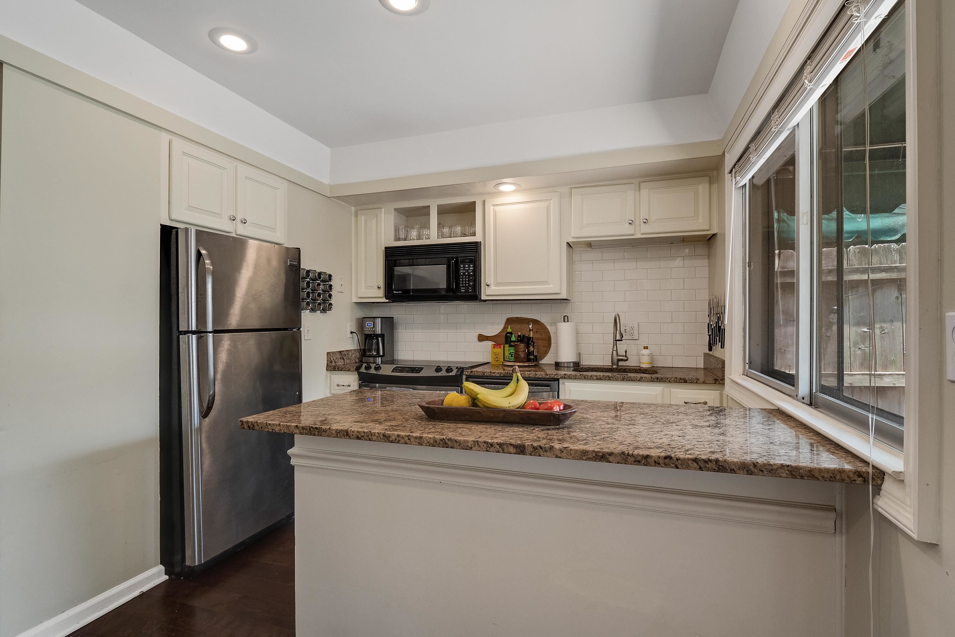 1237 Chamberlain Drive, Unit 1237 Memphis, TN 38119 - Photo 12 of 25 a kitchen with refrigerator a sink and a granite counter tops