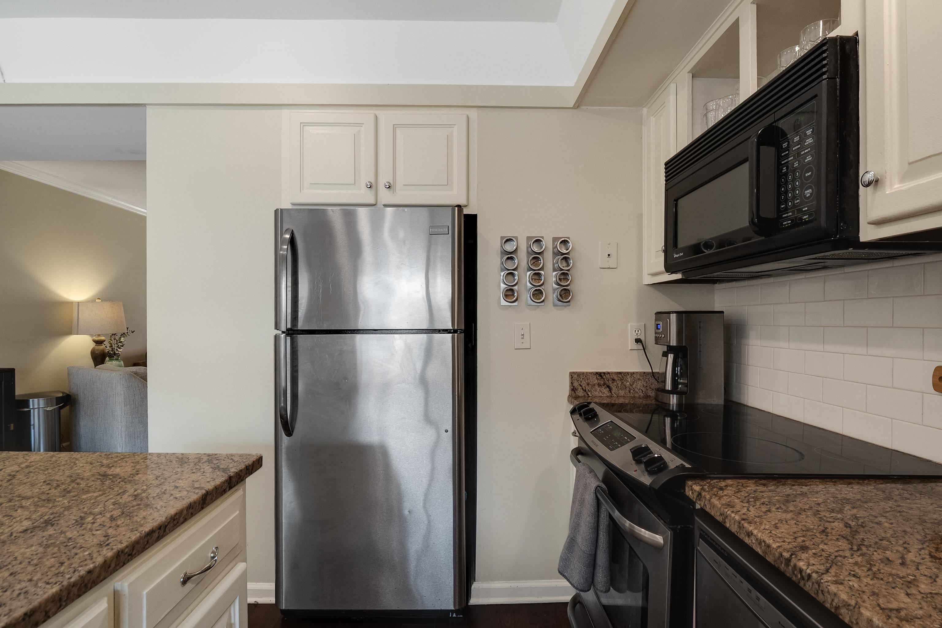 1237 Chamberlain Drive, Unit 1237 Memphis, TN 38119 - Photo 13 of 25 a kitchen with granite countertop a refrigerator stove and microwave