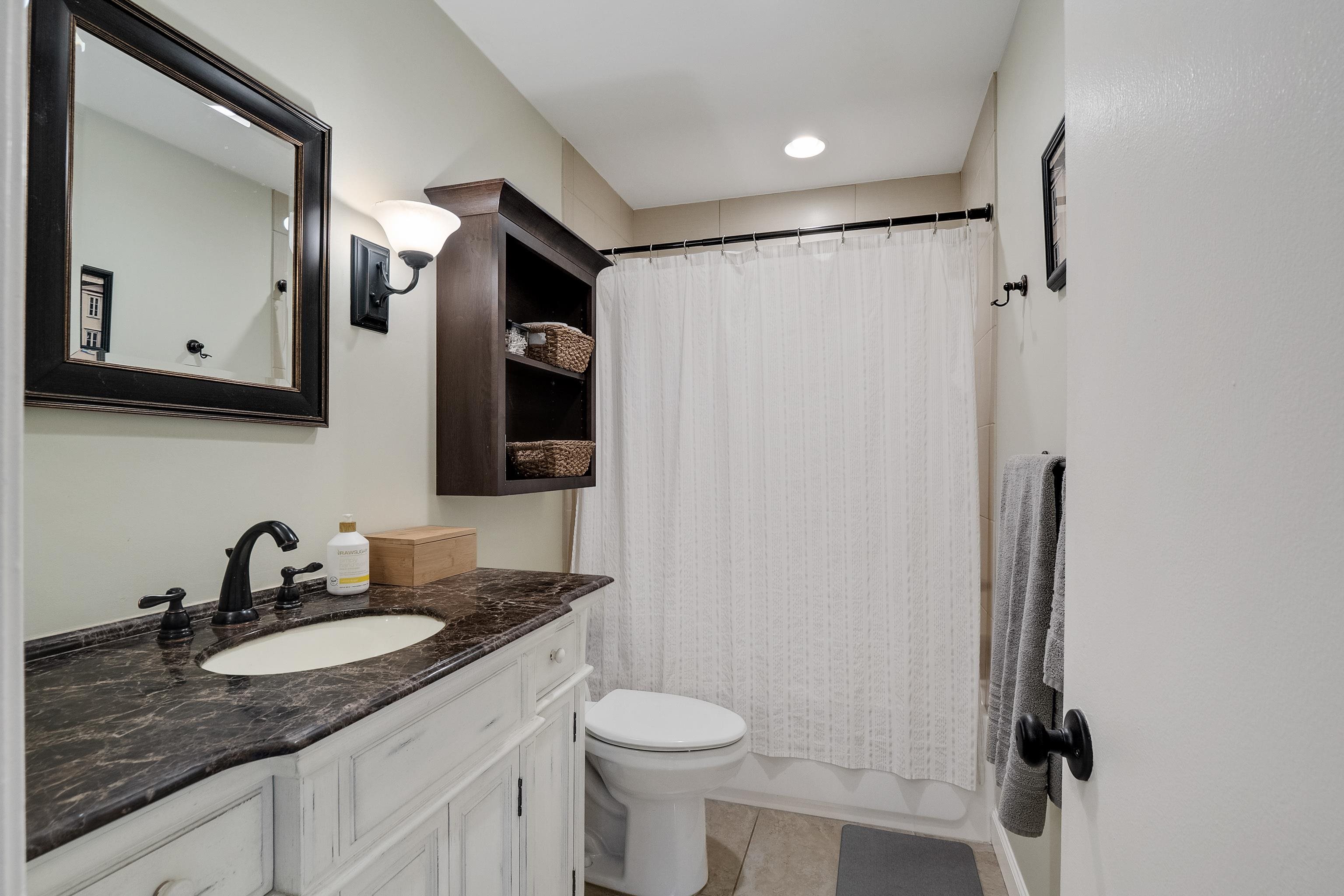 1237 Chamberlain Drive, Unit 1237 Memphis, TN 38119 - Photo 18 of 25 a bathroom with a granite countertop sink toilet and mirror