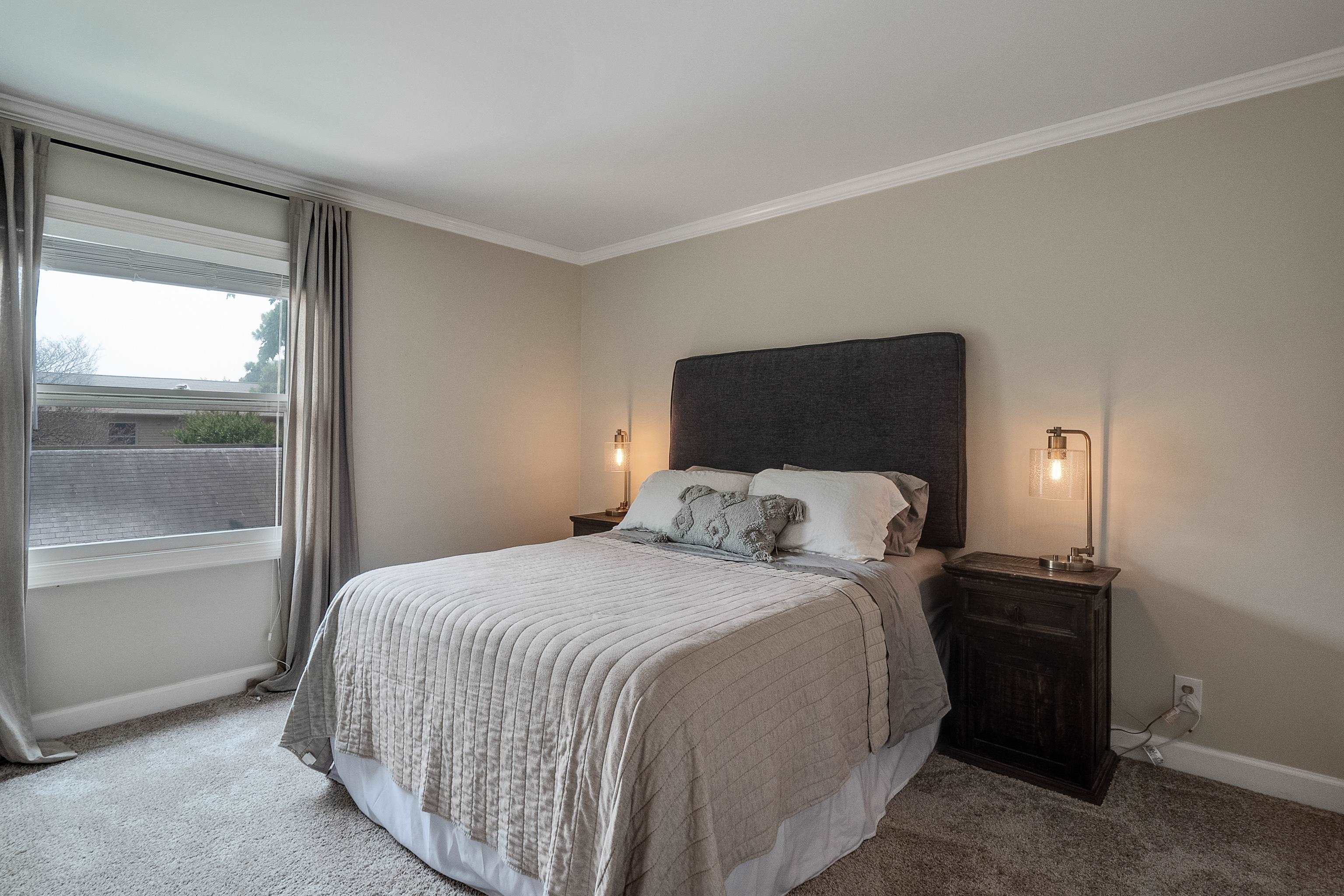 1237 Chamberlain Drive, Unit 1237 Memphis, TN 38119 - Photo 19 of 25 a bedroom with a bed and large mirror