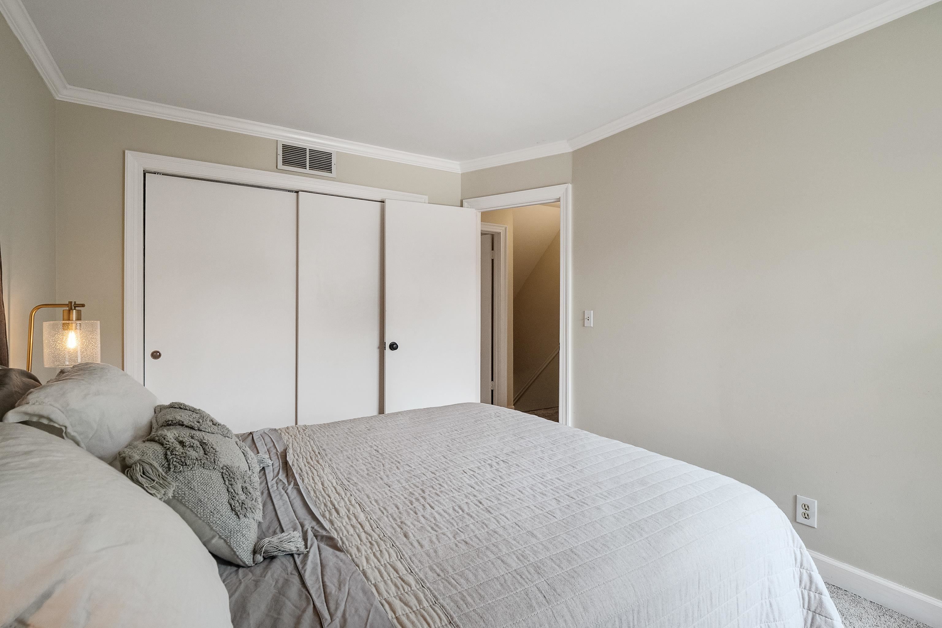 1237 Chamberlain Drive, Unit 1237 Memphis, TN 38119 - Photo 20 of 25 a bedroom with a bed and a mirror