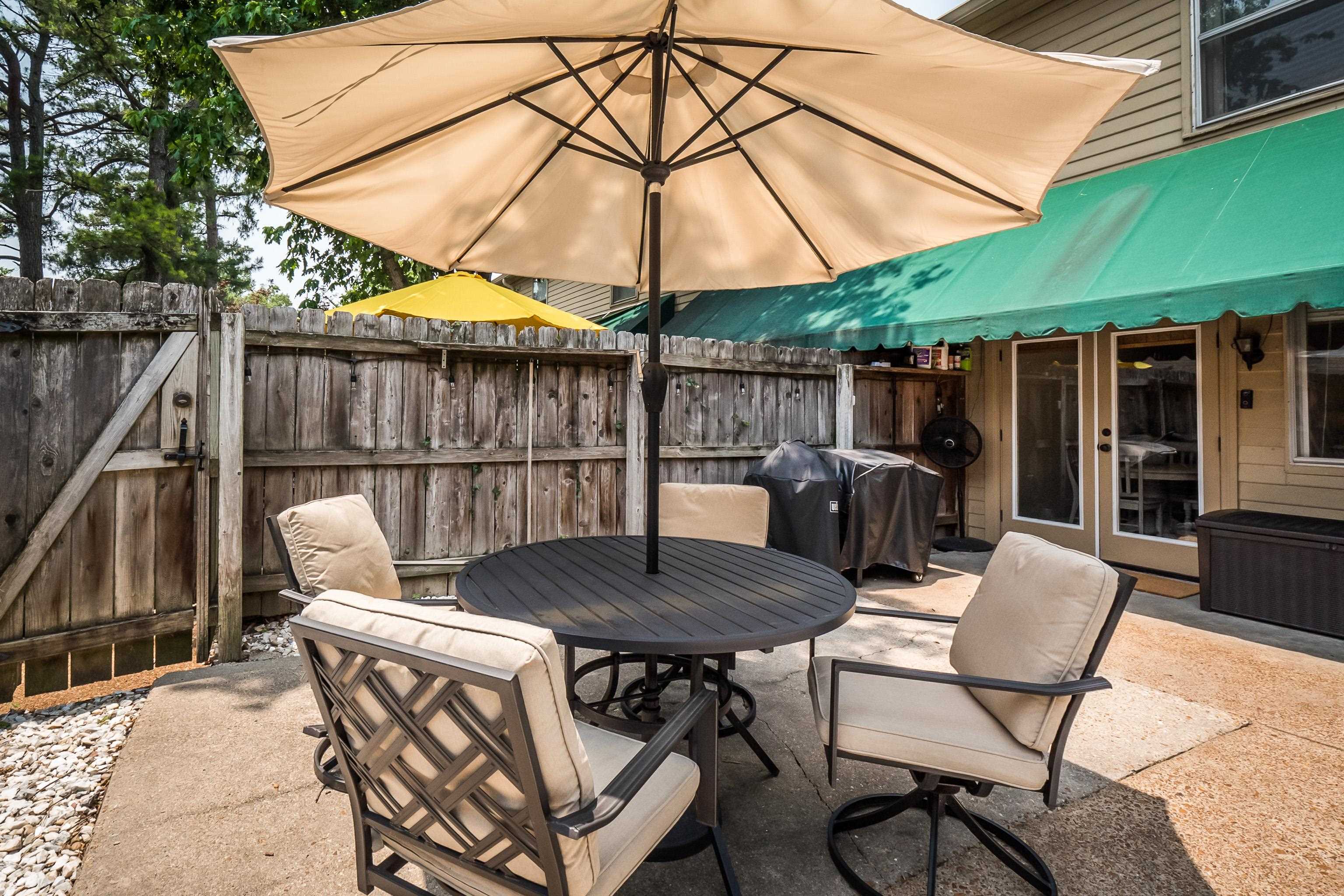 1237 Chamberlain Drive, Unit 1237 Memphis, TN 38119 - Photo 21 of 25 a patio with a patio table and chairs