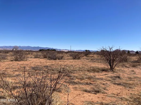 a view of mountain with sunset in background