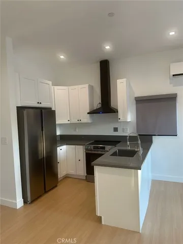a kitchen with a refrigerator and a sink