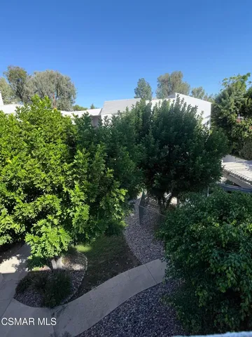 a view of a pathway with a garden