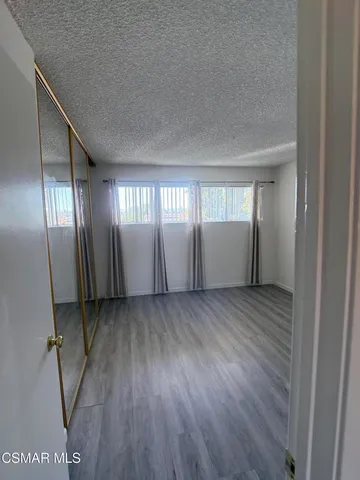 a view of a room with wooden floor and window