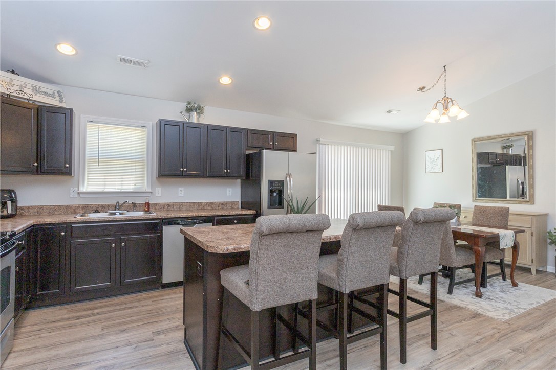 158 Mediterranean Avenue Anderson, SC 29621 - Photo 12 of 39 This bright kitchen and dining area features ample counter space and convenient access to outdoor living.
