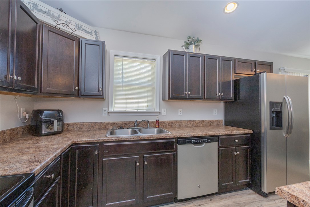 158 Mediterranean Avenue Anderson, SC 29621 - Photo 13 of 39 This functional kitchen features dark cabinetry and essential appliances for daily living.