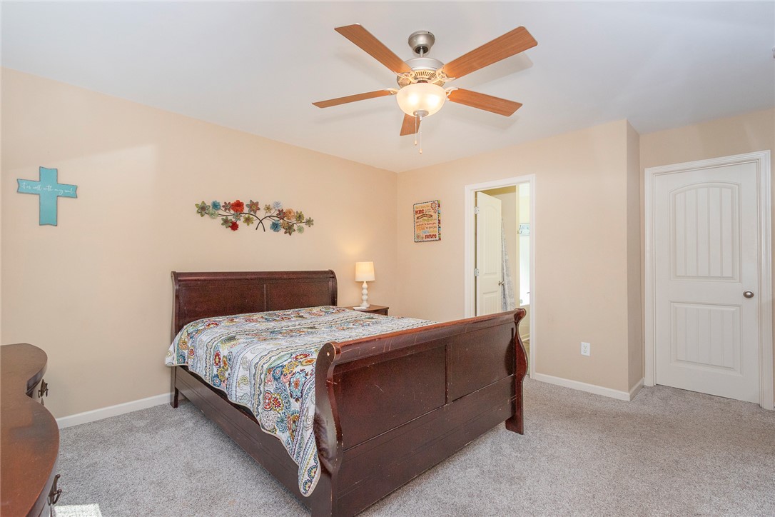 158 Mediterranean Avenue Anderson, SC 29621 - Photo 25 of 39 This cozy bedroom features a ceiling fan, plush carpeting, and a classic paneled door.