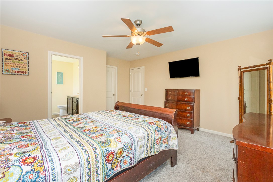 158 Mediterranean Avenue Anderson, SC 29621 - Photo 26 of 39 Comfortable bedroom with an ensuite bathroom, featuring soft carpeting and a ceiling fan.