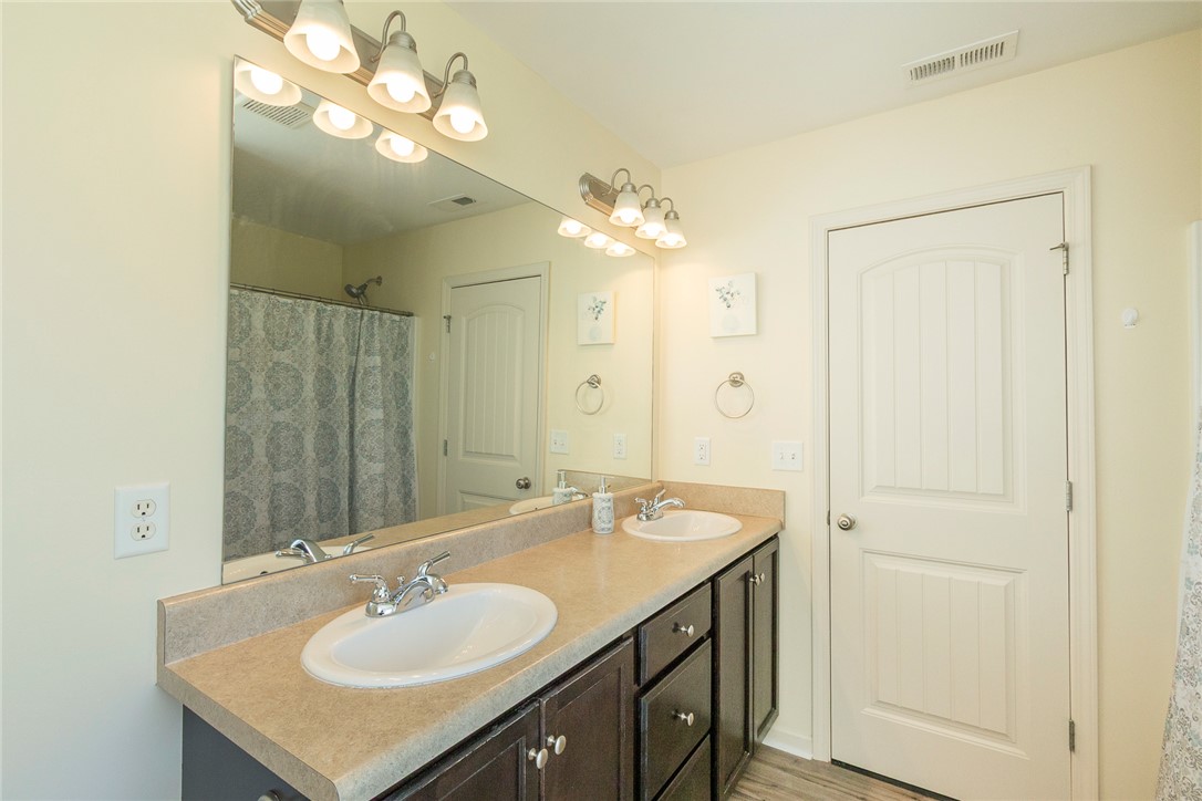 158 Mediterranean Avenue Anderson, SC 29621 - Photo 28 of 39 This spacious bathroom features a functional double vanity and ample mirror space, creating a bright and inviting atmosphere.