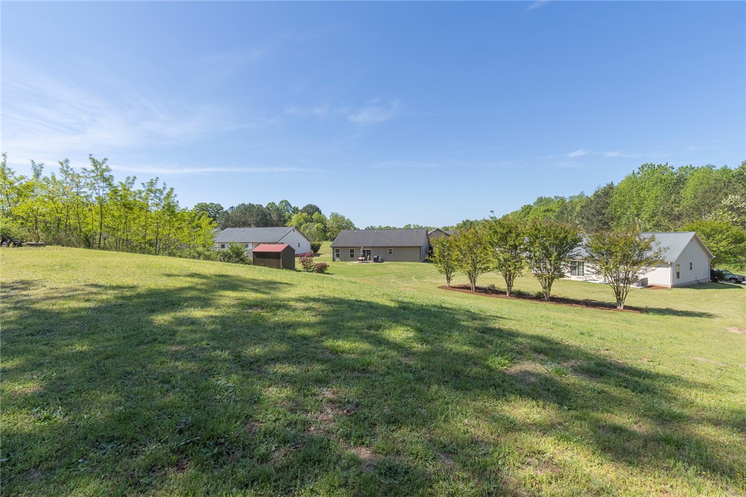 158 Mediterranean Avenue Anderson, SC 29621 - Photo 34 of 39 Expansive green yard with ample space for outdoor activities and beautiful natural surroundings.