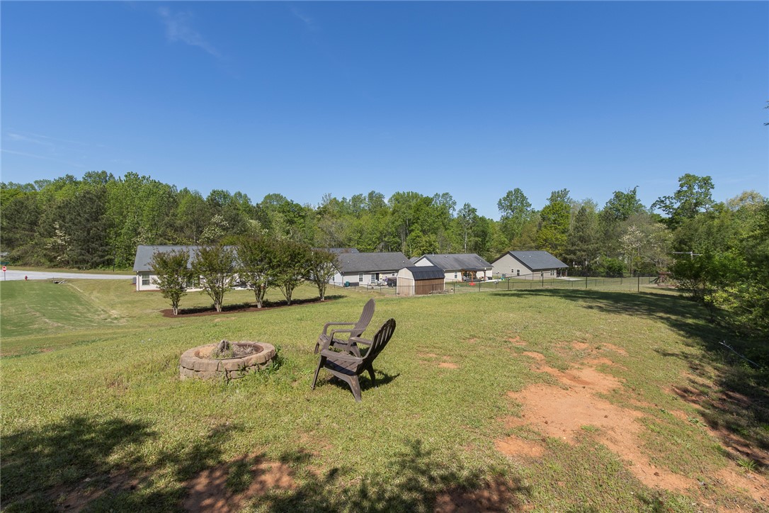 158 Mediterranean Avenue Anderson, SC 29621 - Photo 35 of 39 This spacious yard features a cozy fire pit and ample green space for outdoor activities.