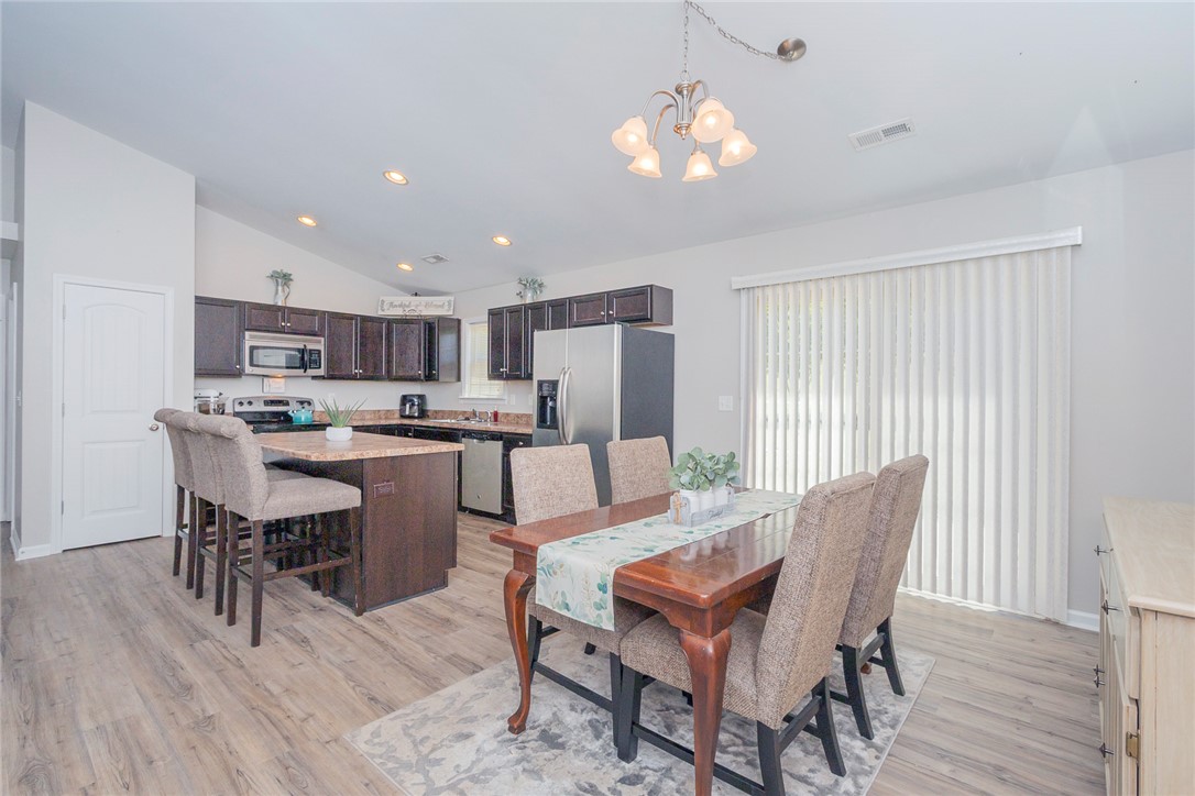 158 Mediterranean Avenue Anderson, SC 29621 - Photo 8 of 39 This inviting dining and kitchen area features wood flooring and a convenient kitchen island for gatherings.