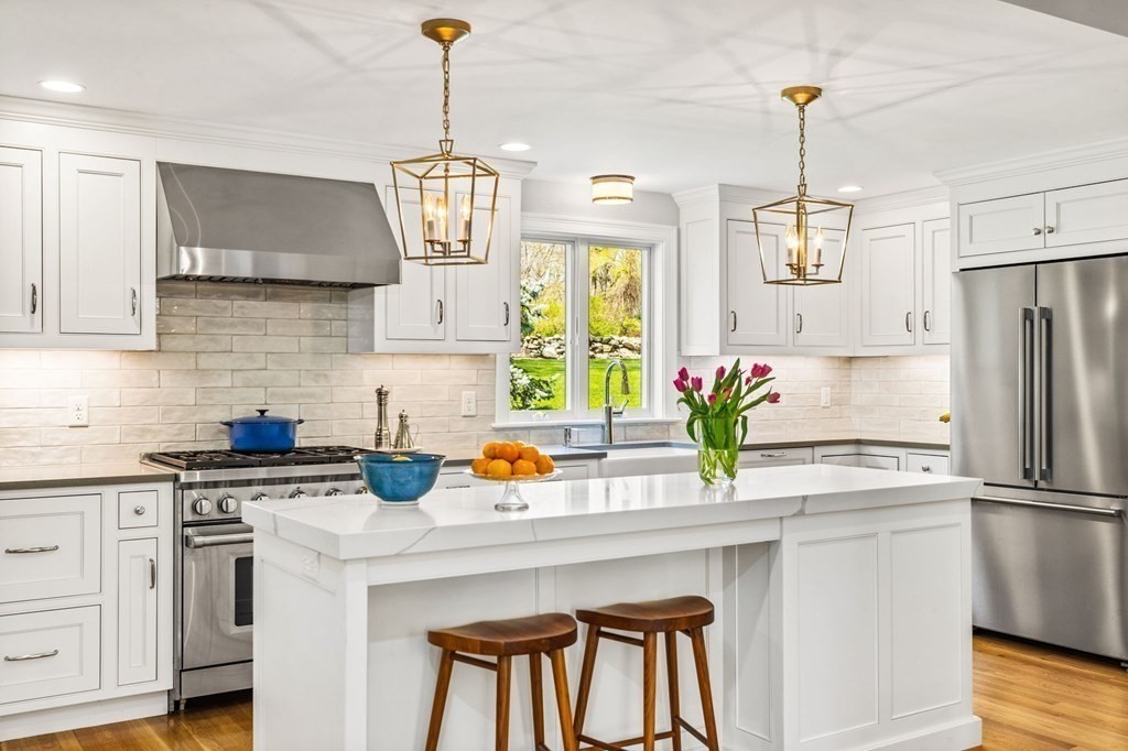 a kitchen with stainless steel appliances a sink stove and refrigerator