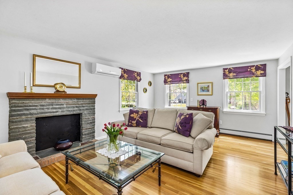 140 Gannett Road Scituate, MA 02066 - Photo 11 of 36 a living room with furniture a rug and a fireplace