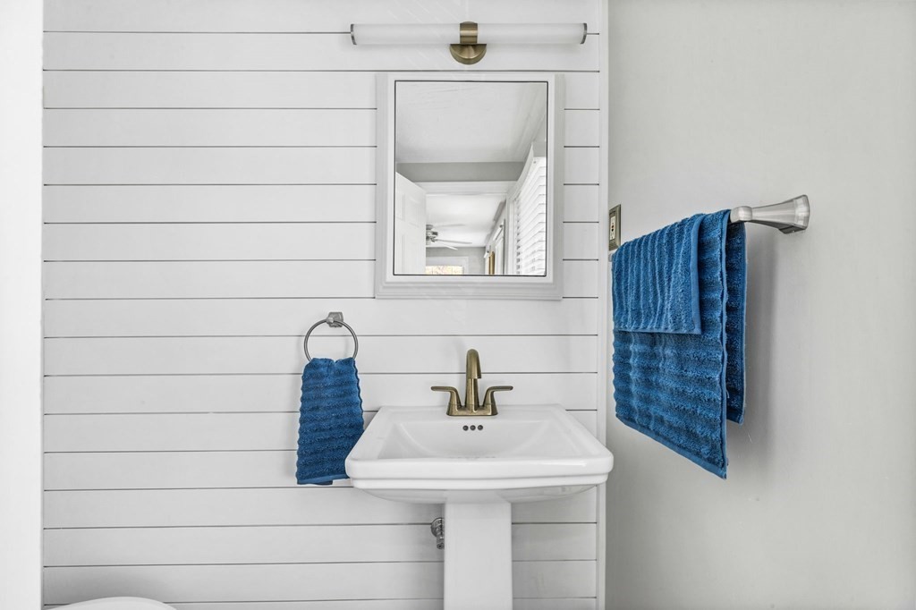 140 Gannett Road Scituate, MA 02066 - Photo 20 of 36 a bathroom with a sink a mirror and a shower