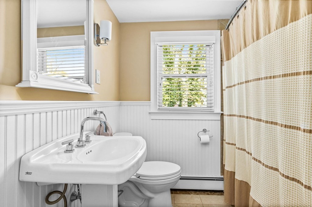 140 Gannett Road Scituate, MA 02066 - Photo 23 of 36 a bathroom with a sink a toilet and a mirror