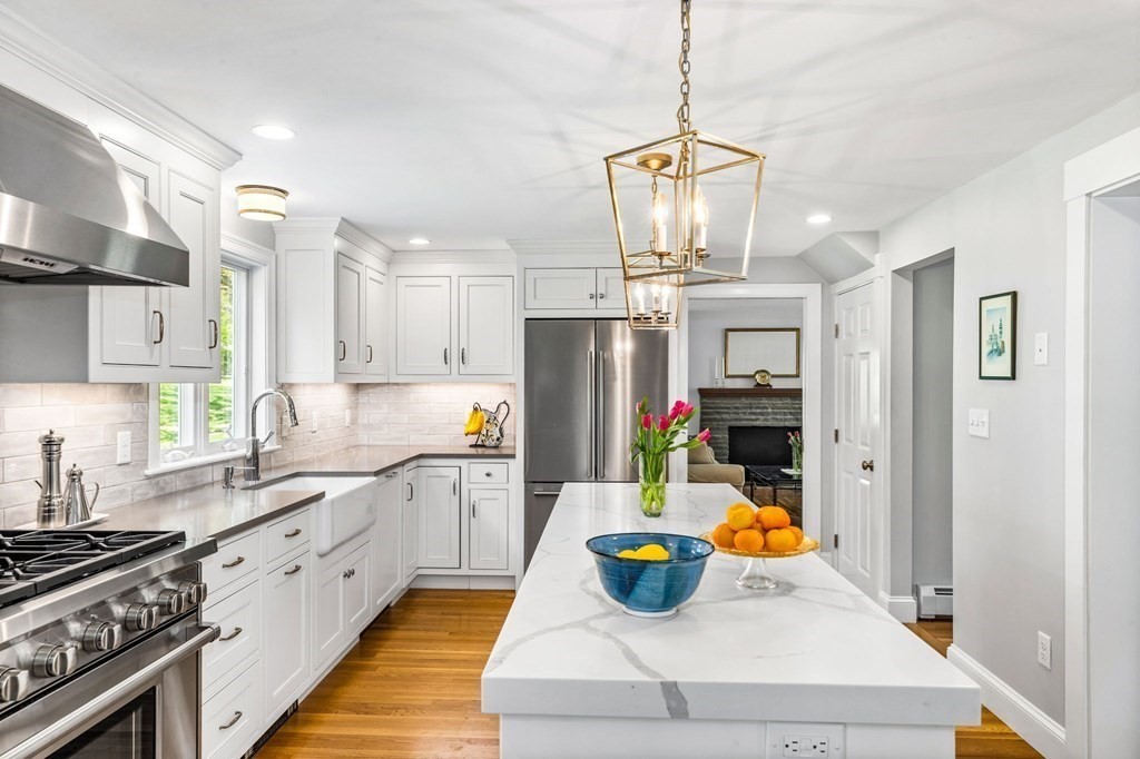 140 Gannett Road Scituate, MA 02066 - Photo 3 of 36 a kitchen with stainless steel appliances granite countertop a sink dishwasher stove and refrigerator with wooden floor