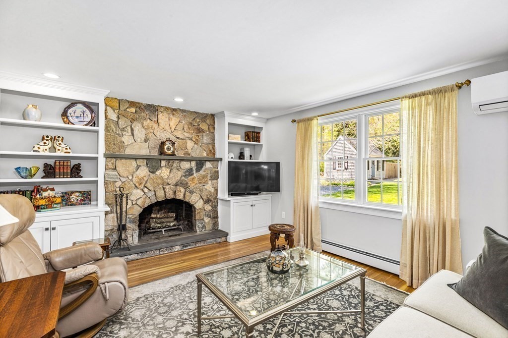 140 Gannett Road Scituate, MA 02066 - Photo 7 of 36 a living room with furniture a rug and a fireplace