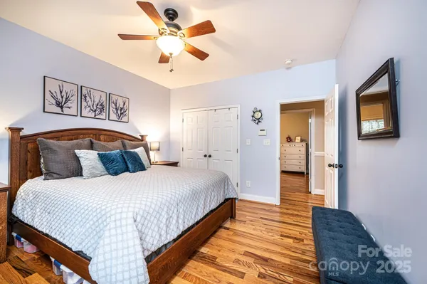 a bedroom with a large bed and a chandelier
