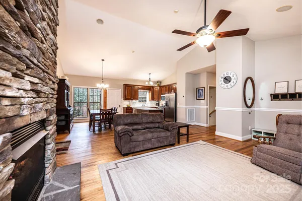 a kitchen with stainless steel appliances granite countertop a sink a stove and a refrigerator