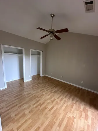 a view of an empty room and wooden floor