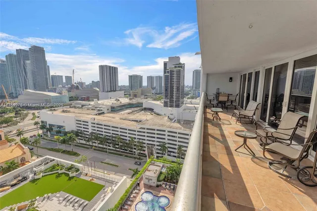 a view of a city from a dining room with furniture