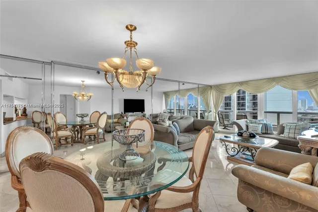 a living room with fireplace furniture and a chandelier