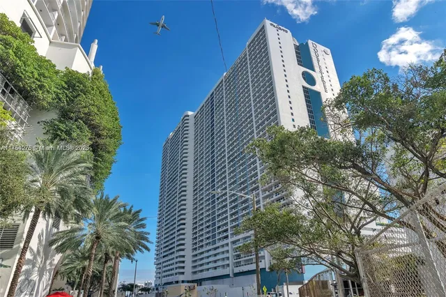 a view of a patio with table and chairs and potted plants