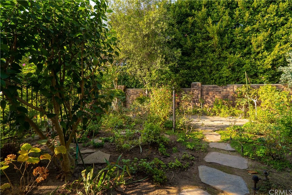 10521 Easter Hill Drive North Tustin, CA 92705 - Photo 22 of 31 Spacious fenced yard (seller secret garden) has been used for cottage style gardening. Would make a great lawn or play area for children) photo shows about half of the space. This area could be opened-up to downstairs family room (paneled wall in FR) to create a more open and outdoor flow to and from the pool and patio areas