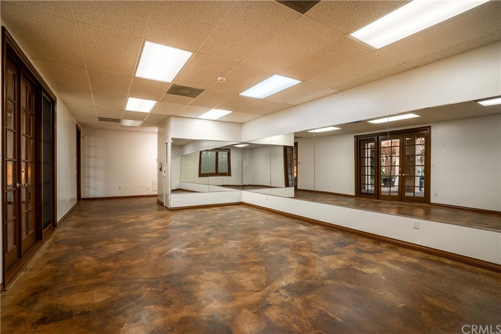 10521 Easter Hill Drive North Tustin, CA 92705 - Photo 24 of 31 Downstairs gym area is located opposite side of pool from the downstairs family room. This area opens to the pool area and could be a separate office for home business, There is a separate access from street. Includes sauna and massive storage area and cedar lined closet for winter and extra clothes storage. So much potential in the 816 sq ft. (not permitted sq. ft)