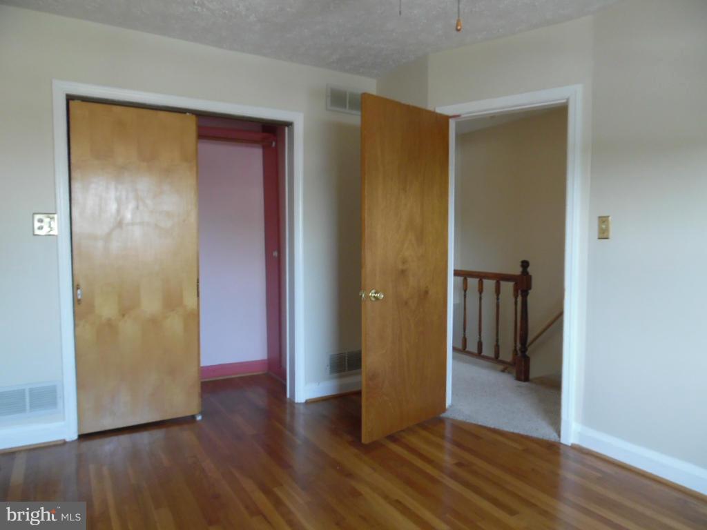 322 Stemmers Run Road Baltimore, MD 21221 - Photo 14 of 19 a view of empty room with wooden floor and closet