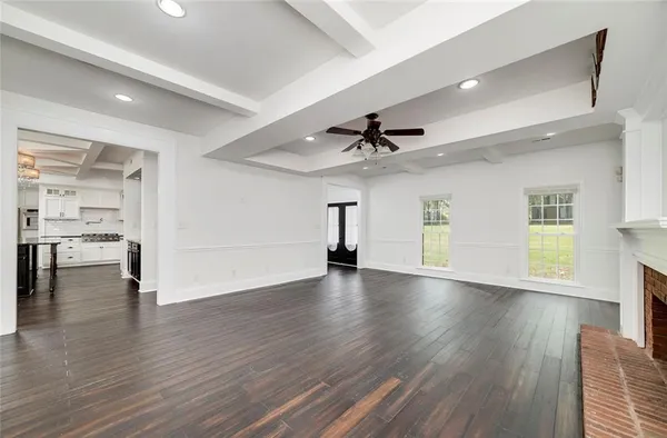 a kitchen with stainless steel appliances a stove a sink a cabinets and wooden floor