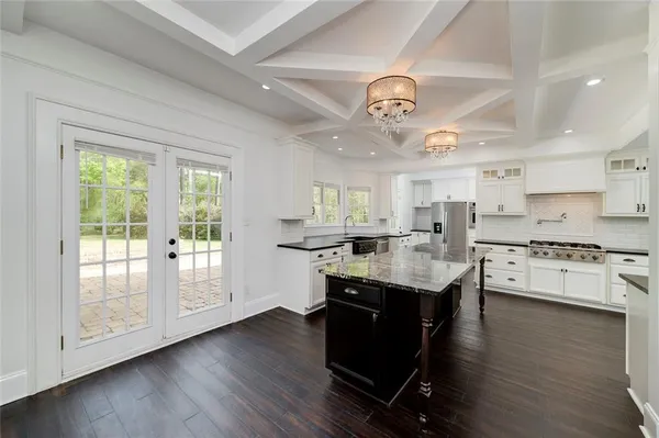 a kitchen with stove a sink and refrigerator