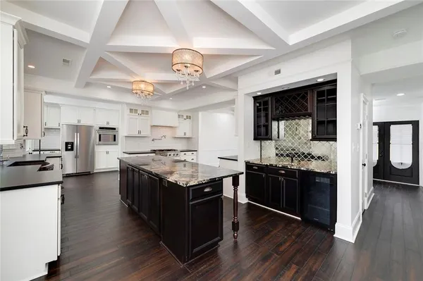 a kitchen with granite countertop a stove and a sink