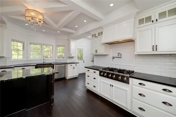a living room with wooden floors and white walls