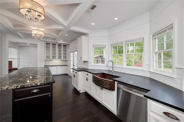 a kitchen with a stove a counter space and a window