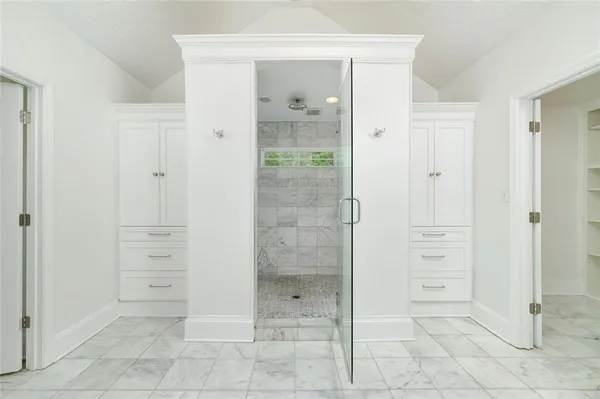 a view of walk in closet with empty racks